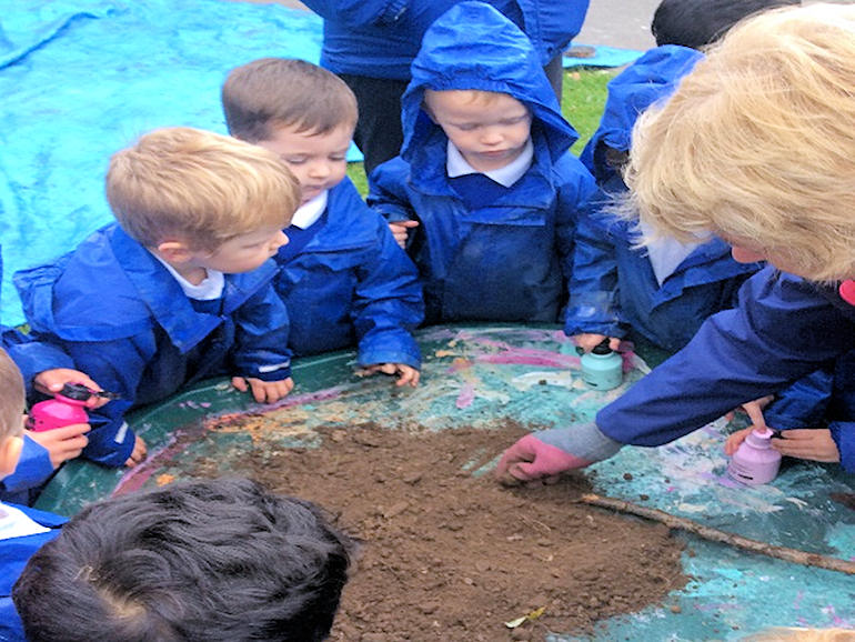 Children learning about soil at Forest School